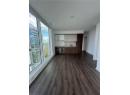 Unfurnished living room featuring dark wood-style floors and track lighting