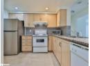 Kitchen with appliances with stainless steel finishes, light brown cabinets, tasteful backsplash, under cabinet range hood, and recessed lighting