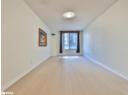 Empty room featuring light wood-type flooring and a textured ceiling