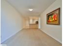 Unfurnished living room featuring baseboards and light wood-type flooring