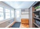 Mudroom with wood ceiling, a barn door, light hardwood / wood-style floors, and vaulted ceiling