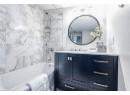 Bathroom with vanity and tiled shower / bath combo