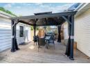 Wooden deck featuring a gazebo, outdoor dining space, and fence