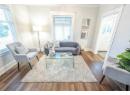 Living room with dark hardwood / wood-style floors and ornamental molding