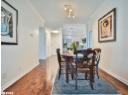 Dining room featuring hardwood / wood-style floors, ornamental molding, and track lighting