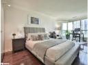 Bedroom featuring ornamental molding, a desk, dark wood finished floors, and a textured ceiling