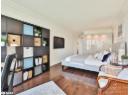Bedroom with crown molding and dark wood-style floors