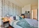 Bedroom featuring ornamental molding and wood finished floors