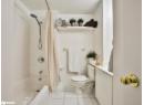 Full bathroom with shower / bathtub combination with curtain, light tile patterned floors, and vanity