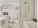 Bathroom featuring vanity, light tile patterned floors, a shower stall, and a garden tub