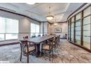 Dining area with crown molding, coffered ceiling, light colored carpet, a tray ceiling, and beamed ceiling