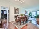 Dining room featuring track lighting, crown molding, and hardwood / wood-style floors