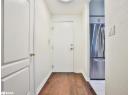 Entryway with wood-type flooring and baseboards