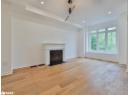 Unfurnished living room featuring a fireplace with flush hearth, light wood-style flooring, and recessed lighting
