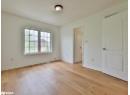 Unfurnished bedroom featuring baseboards and light wood-type flooring