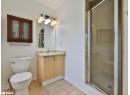 Full bathroom with a stall shower, vanity, and light tile patterned floors