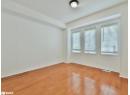 Spare room with baseboards and light wood-style floors