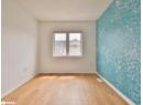 Empty room featuring light wood-style floors and wallpapered walls