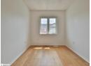Unfurnished room featuring light wood finished floors and baseboards