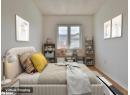 Bedroom featuring wood finished floors and radiator heating unit