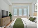 Bedroom featuring multiple windows and wood finished floors