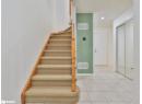 Stairs featuring tile patterned flooring and recessed lighting