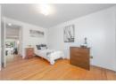 Bedroom featuring light wood finished floors and baseboards
