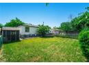 Back of property with a fenced backyard, a patio, and an outdoor structure