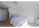 Carpeted bedroom with recessed lighting