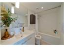 Bathroom featuring shower / tub combo, vanity, light tile patterned floors, and recessed lighting