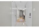 Corridor featuring light tile patterned floors and baseboards