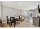 Dining room with light wood-style floors and recessed lighting