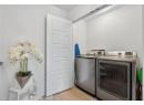Laundry room featuring light wood finished floors and washing machine and dryer