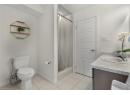 Bathroom featuring vanity, a shower stall, and light tile patterned floors