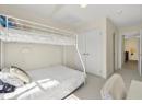 Carpeted bedroom with attic access and a closet