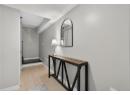 Hall with light wood-type flooring and baseboards