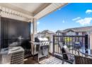 Balcony featuring grilling area and a residential view