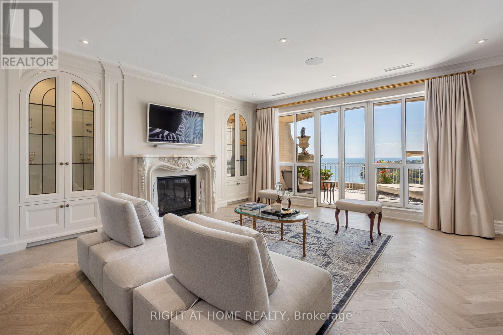 **The Largest Residential Unit in Grand Harbour - A House in the Sky**  this Turnkey Penthouse offers 3,430 sq.ft. of elegant interior space and 1,497 sq.ft. of outdoor living. Designed for seamless indoor-outdoor living, every main room opens to one of four private Covered Balconies and unique sprawling Terrace, perfect for entertaining, gardening, or enjoying sweeping lake and city views.  Inside: 9 Ft. ceilings, expansive rooms, and abundant natural light create a home of generous proportions. Custom kitchen with La Cornue stove and Miele appliances, European Oak Herringbone floors, and 3 fireplaces with Omega mantles reflect exquisite craftsmanship. Dedicated wine room, artistic solid wood doors and thoughtfully selected finishes complete the residence. 3 parking spaces + private locker room. Luxury condo amenities complete this extraordinary residence. **A True House in the Sky  Unmatched in Scale, Design, and Lifestyle** (id:48254)