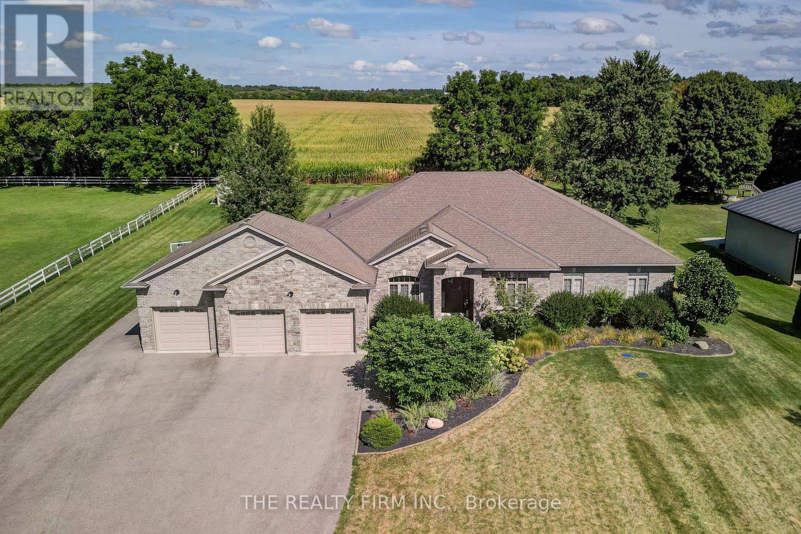 22060 Nissouri Road Thames Centre, Ontario Welcome to your sanctuary of refined rural living at 22060 Nissouri Rd. Thorndale On. A breathtaking estate nestled on 1.33 acres spanning over 5,000 sq ft with exquisitely finished space. This majestic home features 4 + 1 bedrooms and 3.5 baths, crafted with thoughtful design and premium craftsmanship at every turn. Step through the stately entry into a 12' coffered-ceiling foyer with poplar custom trim flowing seamlessly into the family room with its soaring 13 vaulted ceiling and commanding floor-to-ceiling plaster gas fireplace. The kitchen, dazzles with maple cabinetry, a massive island with sink with reverse osmosis, a 6 burner gas stove, double wall ovens and luxe finishes like a travertine backsplash, Brizo faucets and Electrolux ICON fridge/freezer. The main level boasts 10 ceilings, 8 doors, hand scraped oak floors, Italian porcelain tile, granite throughout and an ambient speaker system all complemented by Hunter Douglas window treatments. A convenient main-floor laundry and custom drop zone add to daily ease. The lower level inspires with a stylish wet bar, wine fridge, additional bedroom, full bath, quartz and dual electric fireplaces, oak staircase, spray-foam insulation, separate garage access and a cold room. This property is ideal for multigenerational living with the separate lower level entrance, full amenities and expansive layout. Outside experience meticulously curated 360 landscaping and lighting, stamped concrete walkways and patios, a covered 10' x 25' patio with speakers, insulated attic & 2 extra circuits for a future sunroom addition. Completing the yard is a gas fire pit, a 20' x 22' shed with hydro, gazebo, backyard hydrant and a triple garage with an extra bay door to the back. Thorndale offers tranquility and vibrant community living with playgrounds, splash pad, skate park, sports courts and community gardens. A short drive to Londons premier shopping, business district & airport. The perfect blend of rural and urban charm (id:48254)
