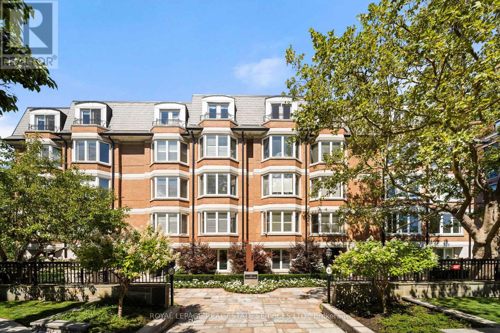 This rare full-floor penthouse at The Riverstone offers 2,959 sq. ft. of living space with sweeping views of both the city skyline and Humber River. Direct elevator access opens to a bright, functional layout featuring engineered hardwood throughout and custom-built cabinetry.  The kitchen includes premium appliances such as a Wolf cooktop and oven, Falmec hood, and custom millwork. The living room features a marble-faced fireplace with quartz hearth, perfect for relaxed evenings or entertaining. The primary suite offers heated stone floors in the ensuite, custom closets, and tranquil views. White oak shaker doors, panels, and baseboards add a consistent, high-end finish throughout. Includes two parking spaces and a locker. Don't miss this opportunity to own a one of a kind penthouse in a highly sought-after building and neighbourhood. (id:48254)