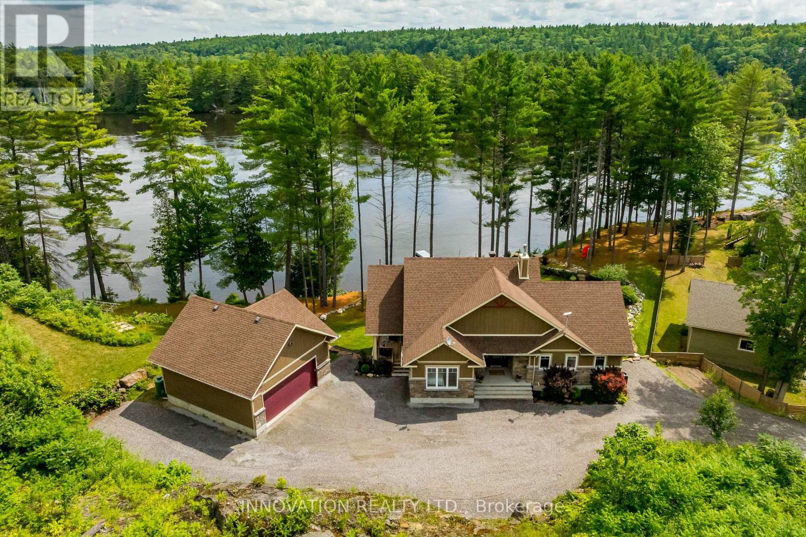 Discover a rare and refined estate on the tranquil banks of the Ottawa River. This custom-built 2019 bungalow offers 4 bedrooms, 3 bathrooms, and over an acre of landscaped privacy surrounded by towering pines. Designed for both comfort and elegance, it's a retreat where luxury and nature meet. Inside, soaring vaulted ceilings and expansive windows frame panoramic river views, filling the open-concept living space with natural light. The chef's kitchen boasts high-end appliances, a generous island, a walk-in pantry, and a reverse osmosis system, ideal for everyday living or hosting with style. The primary suite is a true escape with serene river views, balcony access, and a spa-inspired ensuite featuring a glass shower, deep soaker tub, and dual vanities. A second main-floor bedroom adds convenience, while the walkout lower level offers radiant floor heating, two more bedrooms, a custom recreation space, and direct access to the backyard. Even the laundry room impresses with granite counters, built-in hampers, and soft-close cabinetry. Modern comforts include motorized blinds, programmable thermostats, central air, a Lifebreath air exchanger, and a full HD security system. A detached oversized heated garage provides ample storage and workshop space. Outdoors, the property transforms into a private oasis. Relax year-round in the screened spa lounge with hot tub, gather around the fieldstone fireplace, or head to the floating dock for boating, kayaking, and exceptional fishing, truly a fisherman's dream. Additional perks include an irrigation system, cedar kayak rack, and a charming hobby garage. Every detail has been thoughtfully crafted for ease and enjoyment. This is more than a home, it's a lifestyle. (id:48254)