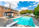 View of swimming pool featuring a patio, a diving board, a fenced backyard, a gazebo, and exterior kitchen