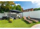 View of yard featuring an outdoor living space with a fire pit, a gazebo, and a patio