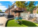 Back of house with a patio, a chimney, brick siding, and outdoor dining space