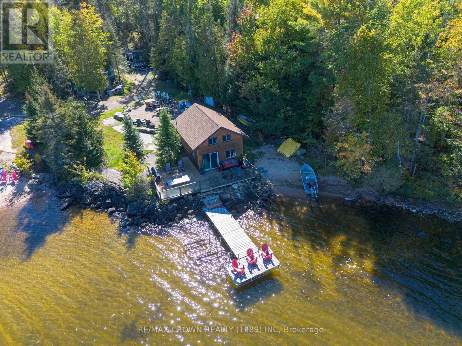 Incredible opportunity to own a one-of-a-kind 4+ acre waterfront compound on beautiful Lake Nipissing, featuring two well-appointed cottages, multiple bunkies, a detached garage, and over 600 feet of pristine shoreline. Backing onto 300 acres of Crown Land, this private retreat offers the perfect blend of comfort, space, and adventure  ideal for families, investors, or those seeking a peaceful lakeside lifestyle. The main cottage is a spacious, four-season home with 3 bedrooms, 2 full bathrooms, and an open-concept kitchen, dining, and living area with walkouts to an expansive deck. Professionally landscaped stone pathways lead you down to the water, where you'll find a sandy beach, multiple docks, and outdoor patios. The second cottage is perched right at the waters edge with spectacular views and world-class sunsets, offering an open-concept kitchen and dining area, 4-piece bath, and cozy loft sleeping space. Step outside to enjoy your morning coffee just steps from the shoreline. The property also features a private boat launch, protected docking for two large boats, a break wall, fire pit, and a large open field perfect for trailers, camping, or hosting gatherings. Whether you're boating, fishing, relaxing by the fire, or exploring in winter by snowmobile or ice fishing gear, this four-season property is truly a rare find on one of Ontario's most sought-after lakes. (id:48254)