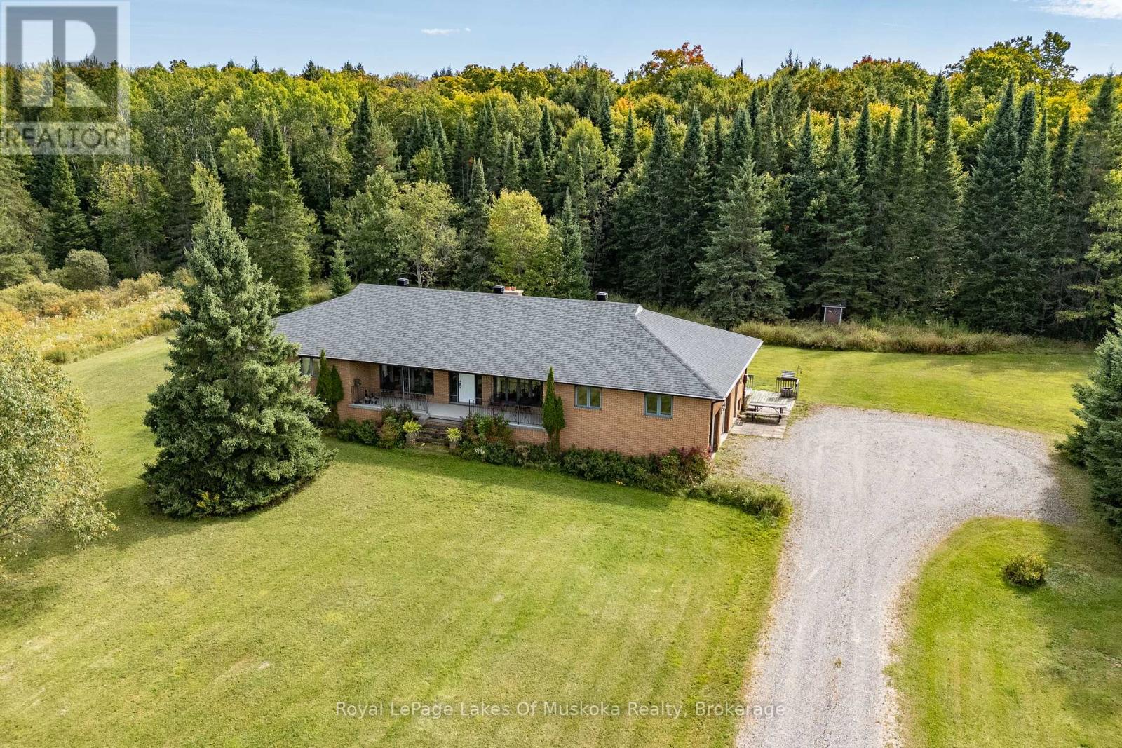 Custom built one owner brick bungalow positioned on a prime 101 acre property in a gorgeous rural area conveniently located only minutes from Bracebridge on a year round municipally maintained road.  This wonderful 3 bed/2 bath home offers a bright & sprawling main floor design that has over 2200 sq ft of living space with large principal rooms & lots of extras throughout. Features include; a large custom kitchen with ample cupboard space, built-in oven, cook top range & a large eat-in dining/breakfast area w/walkout to south facing deck; sunk in living room w/hardwood floors & wood fireplace insert, formal dining room w/French doors into the large family/sitting room w/hardwood floors & walkout to 32' covered verandah overlooking the beautiful front yard. Main floor laundry, 2 full baths & 3 generously sized main floor bedrooms. Full basement is unfinished but offers an additional 2,100+ sq ft of space & has excellent finishing potential & loads of storage space + separate workshop room. Double attached garage (20' x 22') with inside access. The property features a large frontage on the year round road with a level cleared pasture area with existing fenced paddocks, 24' x 26' shed/barn (previously used for horses), zoned RU3/RU1 which allows for several permitted uses, trails throughout the property would be Ideal for horses/hobby farm or just having your own piece of heaven. Forced air wood/electric heating system, air filter system, generator panel, drilled well & more. Property packages like this one don't come along often. (id:48254)