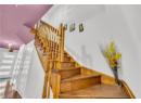 Staircase with wood finished floors and baseboards