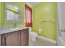 Bathroom featuring light tile patterned flooring, vanity, and shower / bath combo with shower curtain