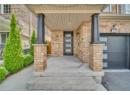 Doorway to property featuring a porch and brick siding
