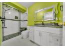Full bathroom with a marble finish shower, vanity, and light marble finish flooring